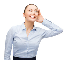 Image showing smiling businesswoman listening gossig