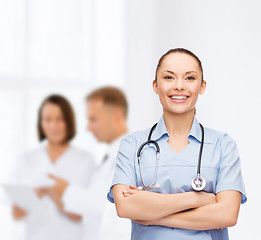 Image showing smiling female doctor or nurse with stethoscope