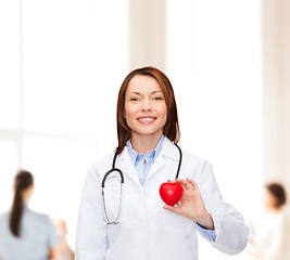 Image showing smiling female doctor with heart and stethoscope