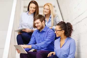 Image showing team with tablet pc computer sitting on staircase