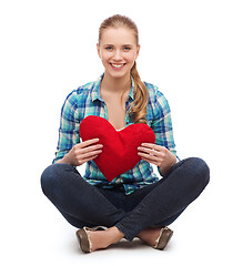 Image showing young woman in casual clothes sitting on floor