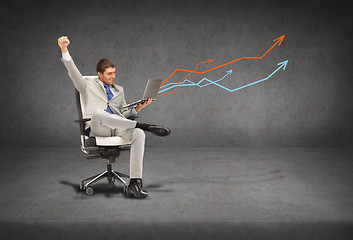 Image showing young businessman sitting in chair with laptop