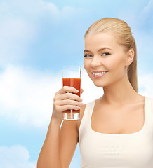 Image showing smiling woman holding glass of tomato juice