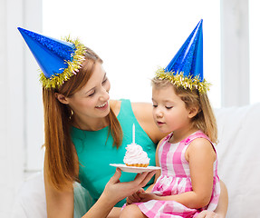 Image showing mother and daughter in blue hats with cake