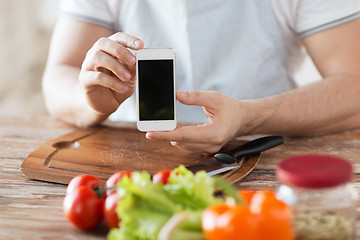 Image showing close up of male hands holding smartphone