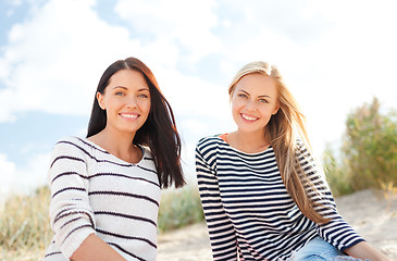 Image showing smiling girlfriends having fun on the beach
