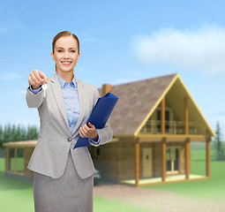 Image showing smiling businesswoman with folder and keys