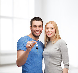 Image showing smiling couple holding keys