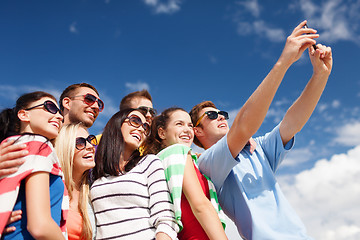 Image showing group of friends taking picture with smartphone