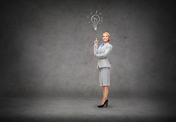 Image showing attractive young businesswoman with her finger up