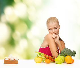 Image showing doubting woman with fruits and pie