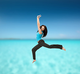 Image showing sporty woman jumping in sportswear