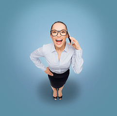 Image showing happy businesswoman in eyeglasses with smartphone