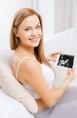 Image showing happy pregnant woman with ultrasound picture