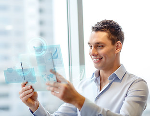 Image showing smiling businessman with tablet pc in office