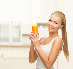 Image showing smiling woman holding glass of orange juice
