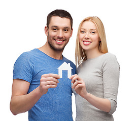 Image showing smiling couple holding white paper house