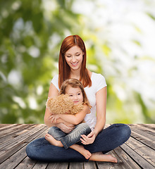 Image showing happy mother with adorable girl and teddy bear