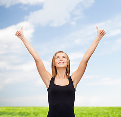 Image showing woman in blank black tank top showing thumbs up