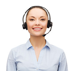 Image showing friendly female helpline operator with headphones