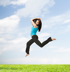 Image showing sporty woman jumping in sportswear