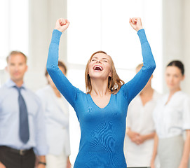 Image showing laughing young woman with hands up