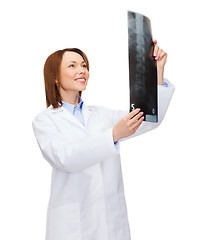 Image showing smiling female doctor looking at x-ray