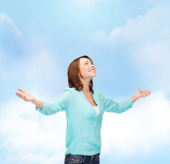 Image showing smiling woman waving hands