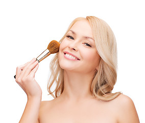 Image showing beautiful woman with closed eyes and makeup brush