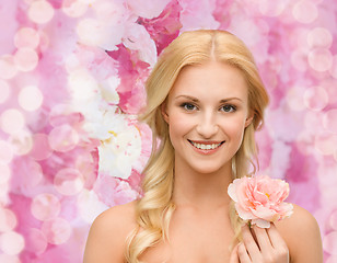 Image showing smiling woman with peony flower