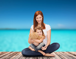 Image showing happy mother with adorable girl and teddy bear