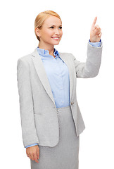 Image showing smiling businesswoman working with virtual screen