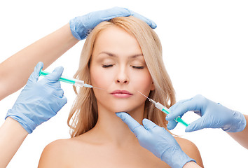 Image showing woman face and beautician hands with syringes