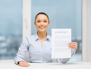 Image showing happy businesswoman holding contract in office