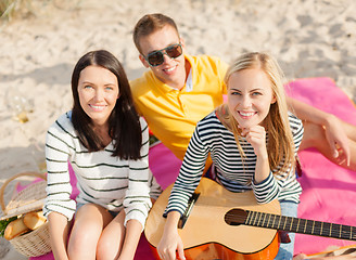 Image showing group of friends with guitar having fun on beach