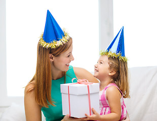 Image showing mother and daughter in blue hats with favor horns