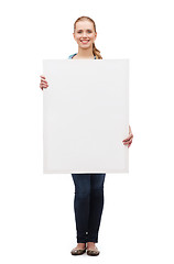 Image showing smiling young woman with white blank board