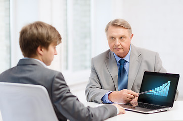 Image showing older man and young man with laptop computer