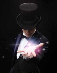 Image showing magician holding something on palm of his hand