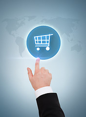 Image showing close up of businessman pointing to shopping cart