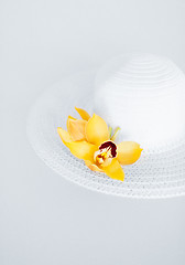 Image showing closeup of white hat and flowers