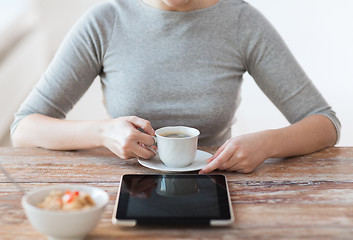 Image showing woman drinking coffee and using tablet pc