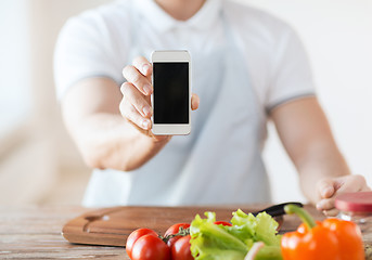 Image showing close up of male hands holding smartphone