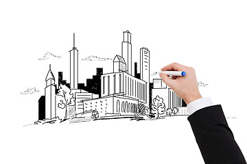 Image showing close up of businessman drawing city sketch