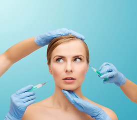 Image showing woman face and beautician hands with syringe