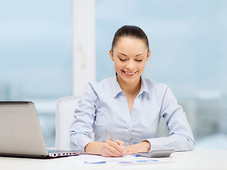 Image showing businesswoman working with documents in office