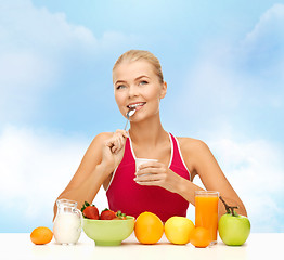 Image showing young woman eating healthy breakfast