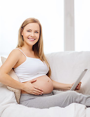 Image showing smiling pregnant woman with tablet pc computer