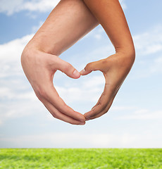 Image showing woman and man hands showing heart shape