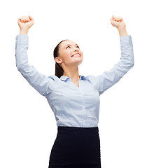 Image showing smiling businesswoman with hands up